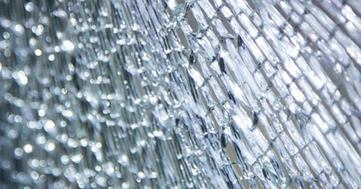 Close-up of shattered tempered glass broken into small blunt pieces