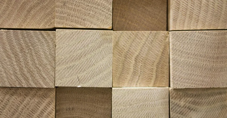 Stacked hardwood boards ready to be cut to size as a replacement bed slat