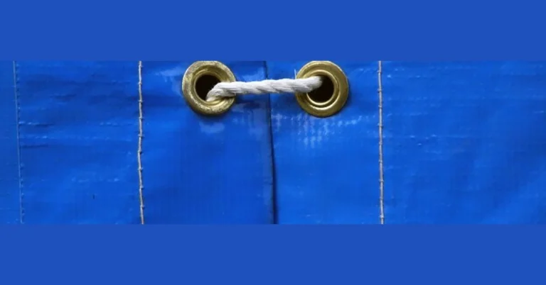 Brass eyelet grommets in a blue tarp with rope tied through