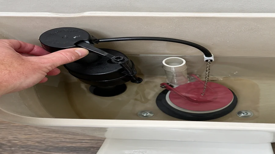 Toilet tank checked after a replacement flapper did not stop running water