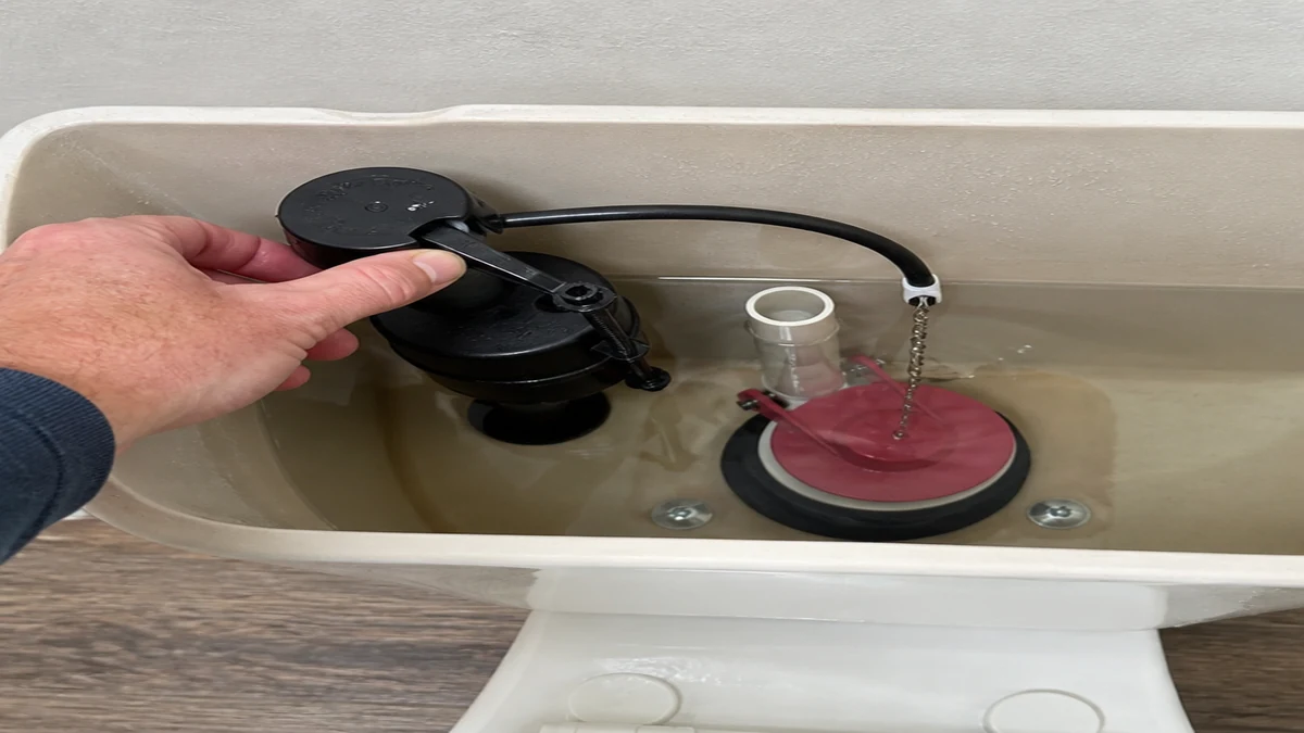 Toilet tank checked after a replacement flapper did not stop running water