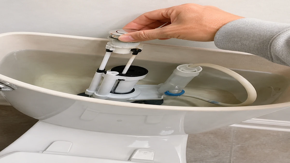 Push-button toilet flush mechanism inspected inside an open cistern