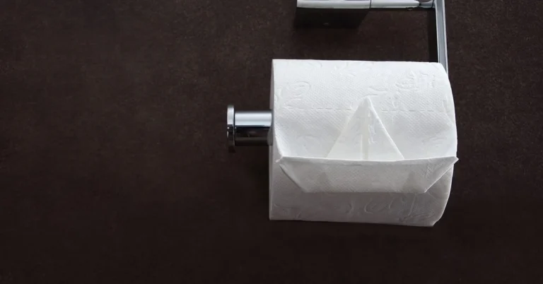 Toilet paper roll folded on a wall-mounted holder