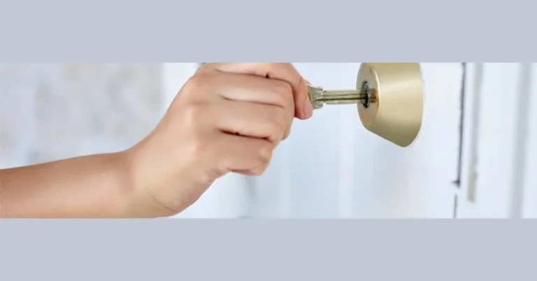 hand turning a key to unlock a door lock cylinder