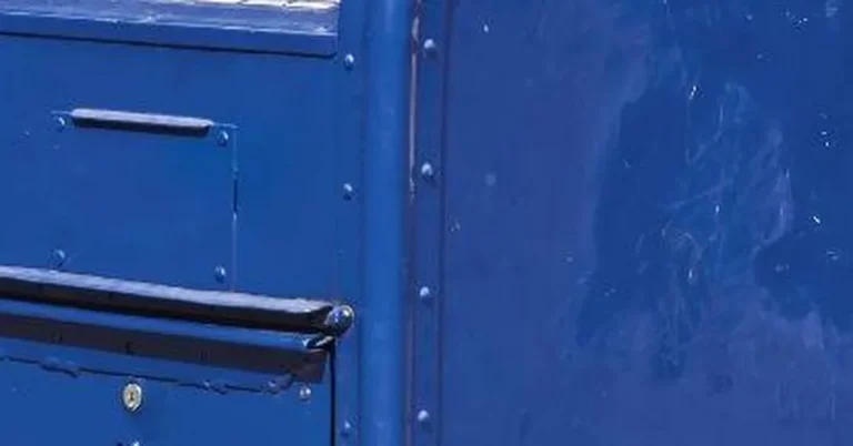 USPS blue mail collection box on a street corner