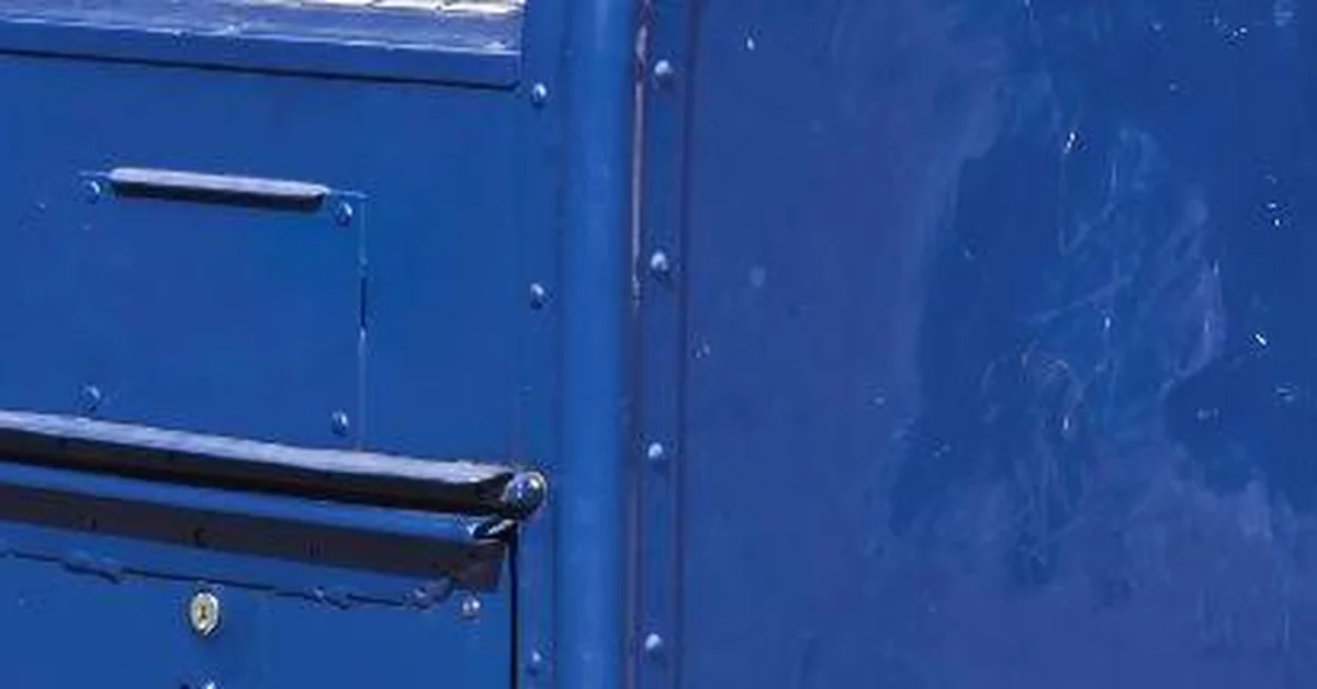 USPS blue mail collection box on a street corner