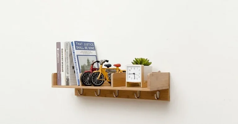 Wall-mounted wood shelf on bracket supports holding books and decor