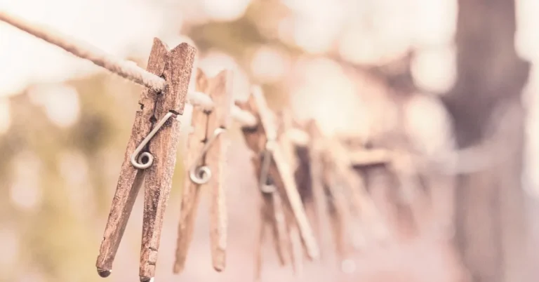 Wooden clothespins clipped to an outdoor laundry line