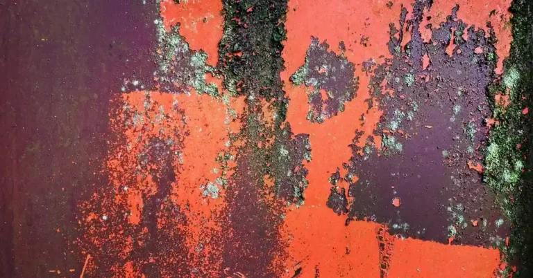 Paint bubbling and peeling along a wall and ceiling joint
