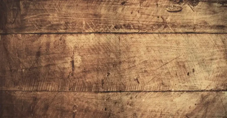 A close-up of scratched wood flooring.