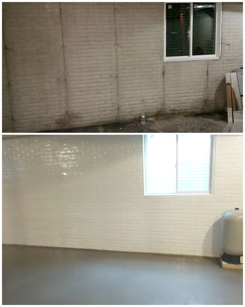 Basement waterproofing scene with a homeowner and contractor inspecting damp walls and a small puddle.
