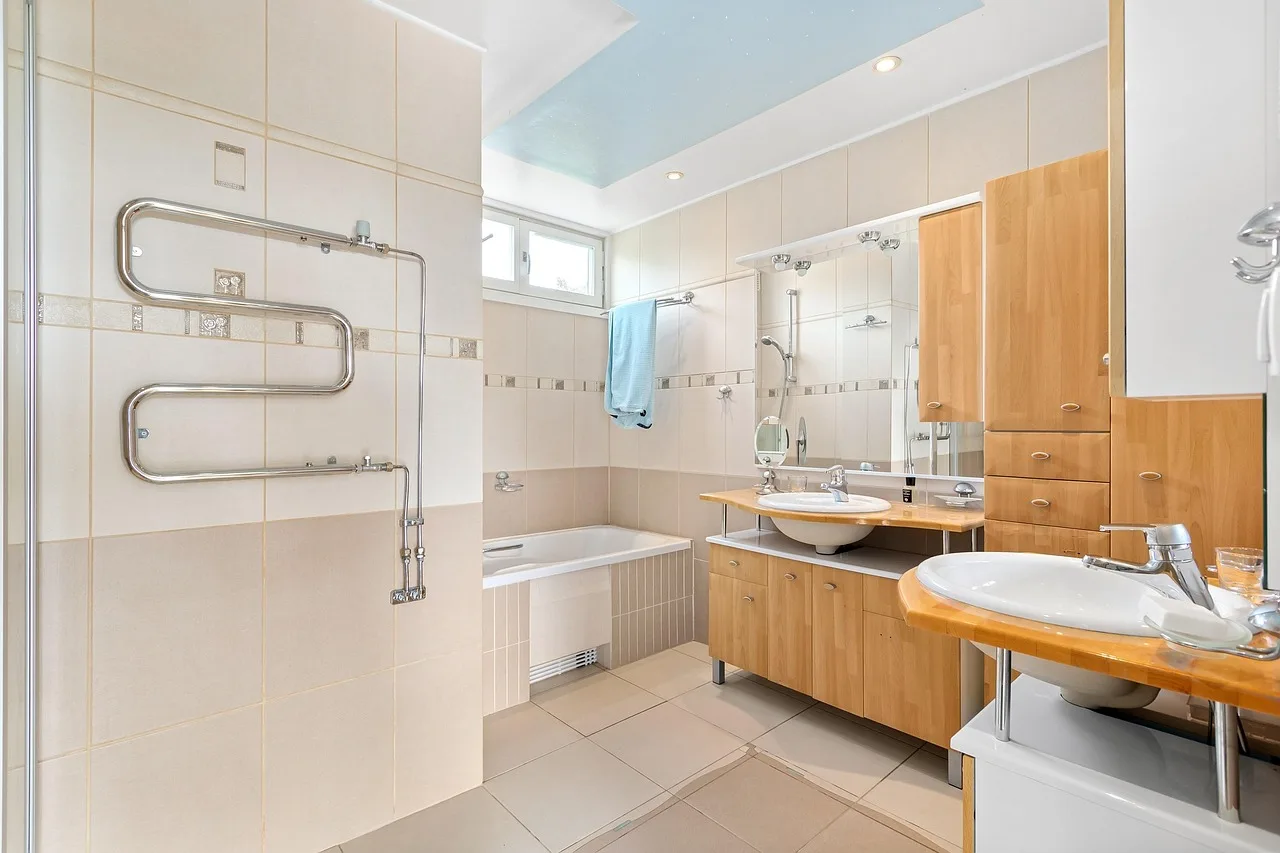 Should a bathroom fan be centered in the room or placed near the shower?