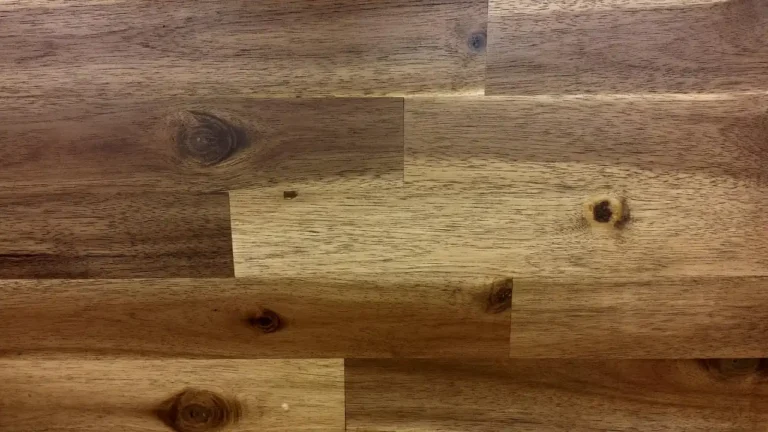 Homeowner compares laminate underlayment options on a wood subfloor beside open flooring planks