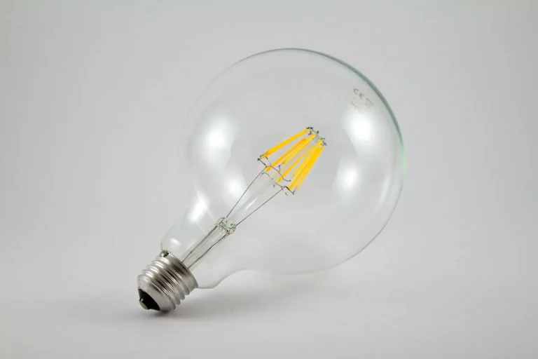 Homeowner comparing LED bulb brands on a table in a bright living room