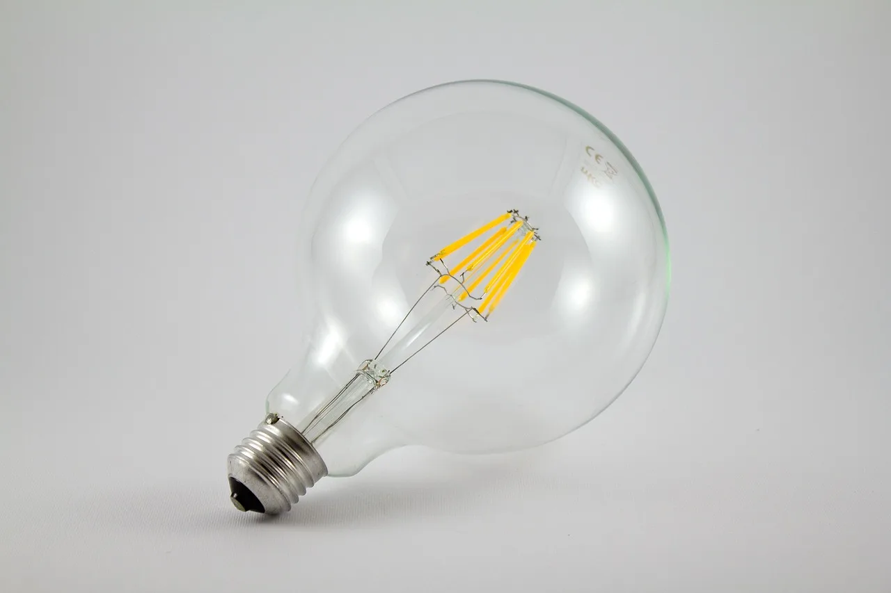 Homeowner comparing LED bulb brands on a table in a bright living room
