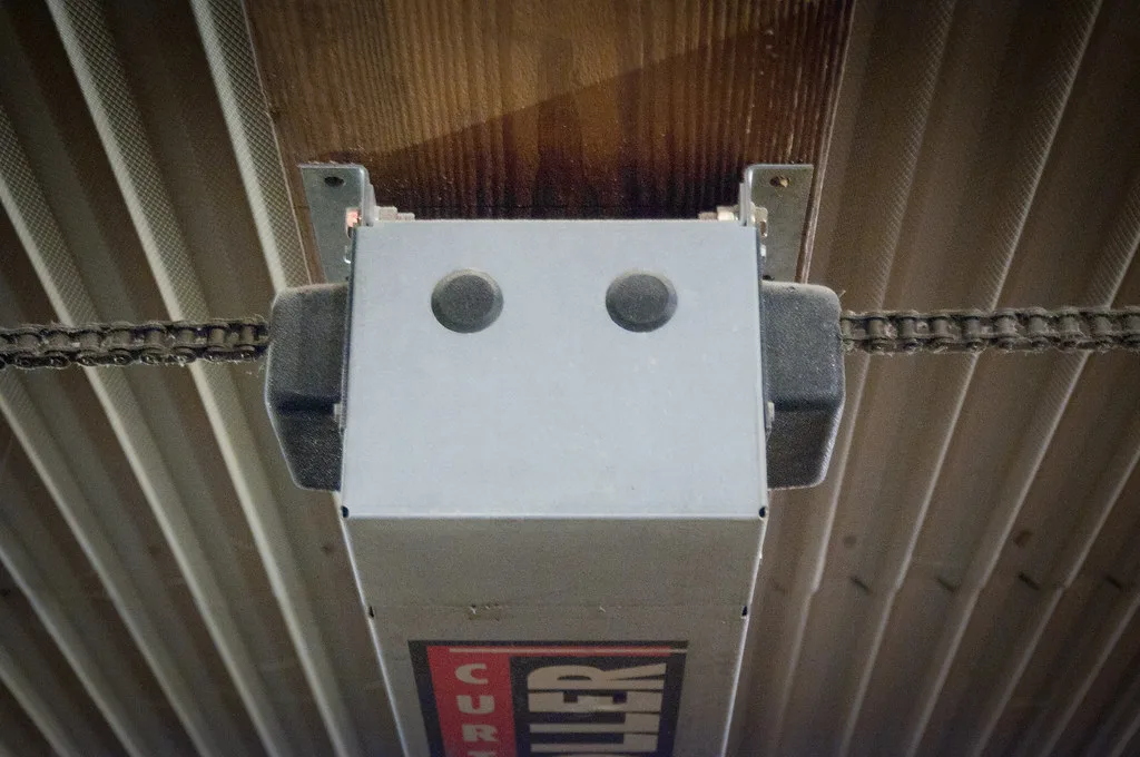 Close-up of DC and AC ceiling fan motor parts on a workbench for comparison.