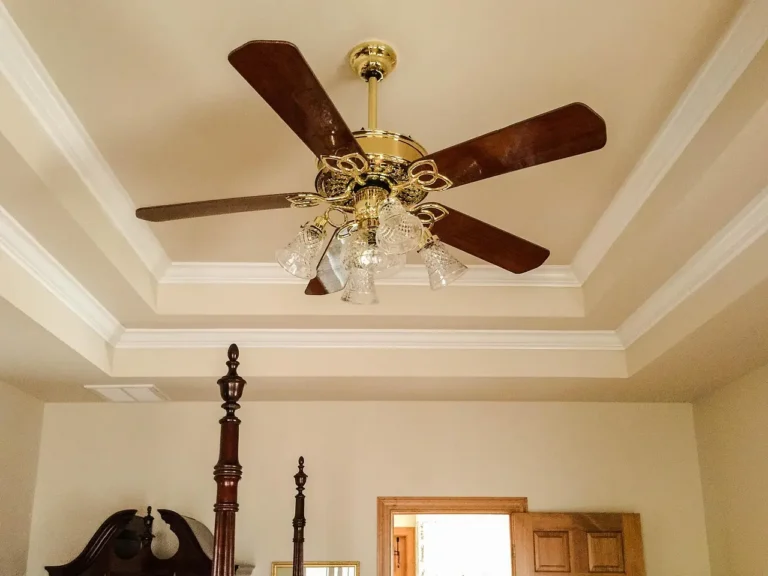 Homeowner and designer compare crown molding, baseboards, and casing in a bright living room