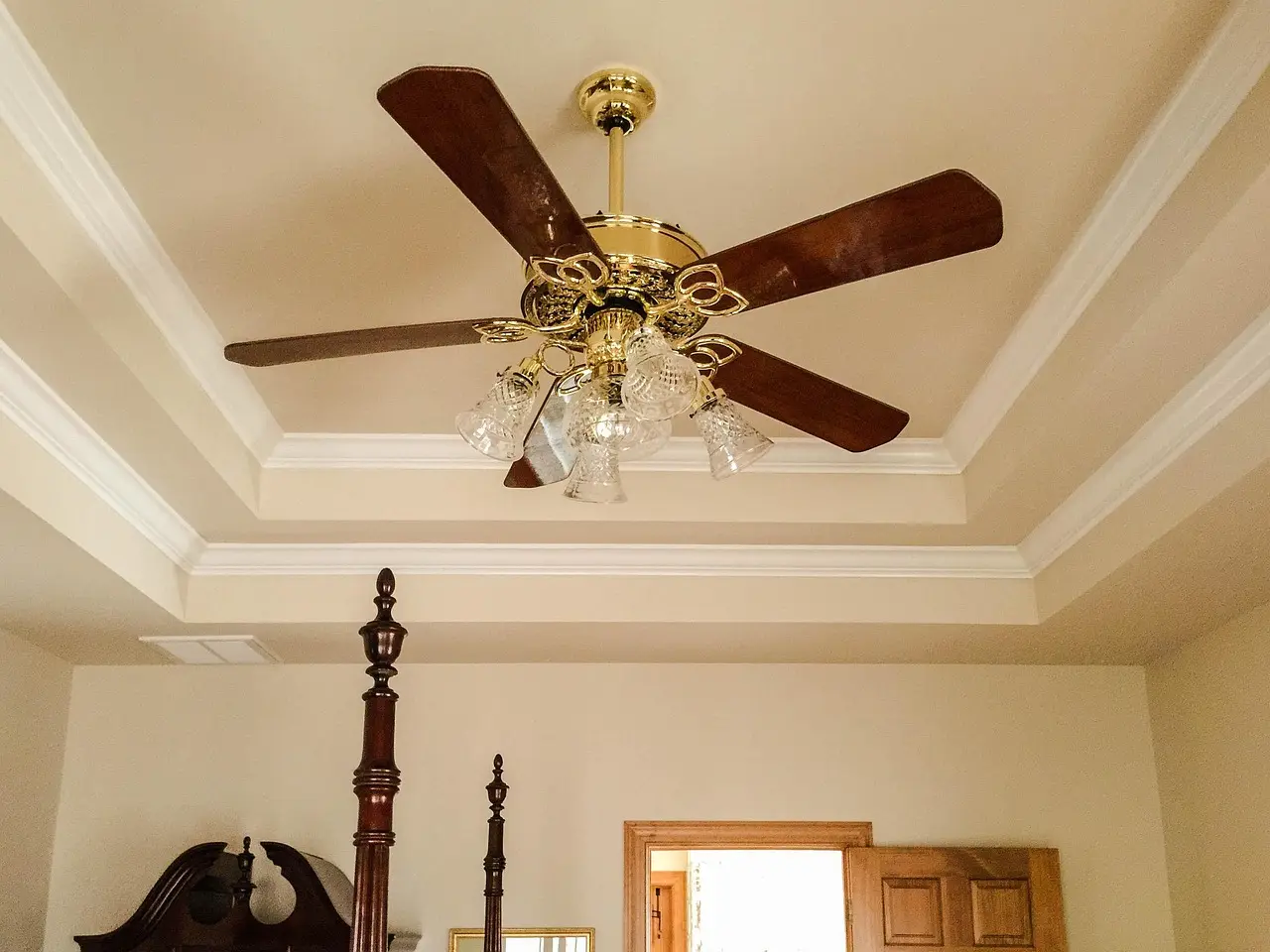 Homeowner and designer compare crown molding, baseboards, and casing in a bright living room