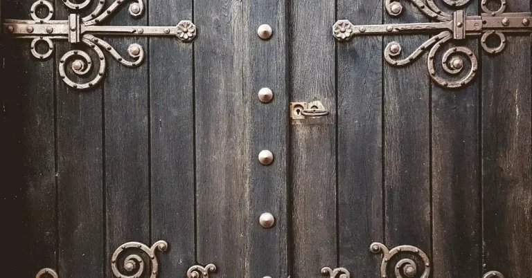 Close-up of a metal door hinge where friction can cause creaking