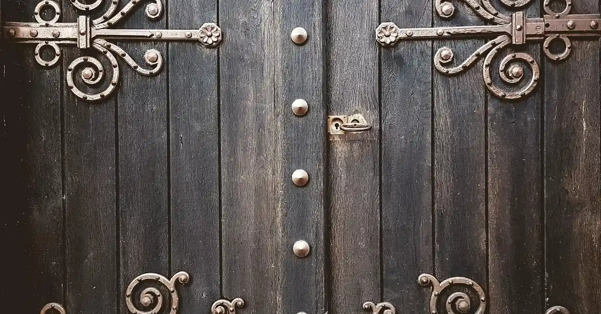 Close-up of a metal door hinge where friction can cause creaking
