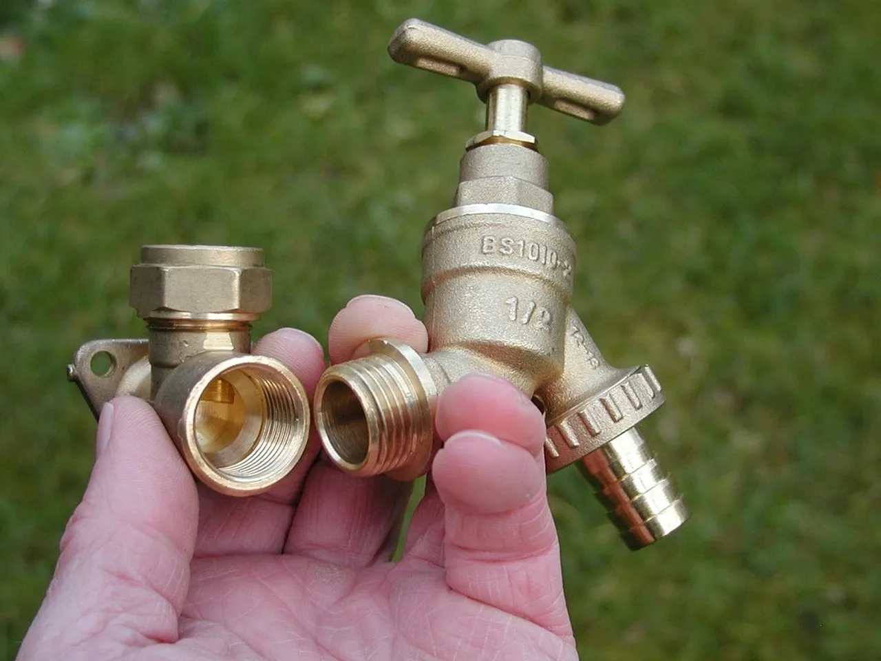 Homeowner diagnosing a dripping bathroom faucet beside tools and replacement parts