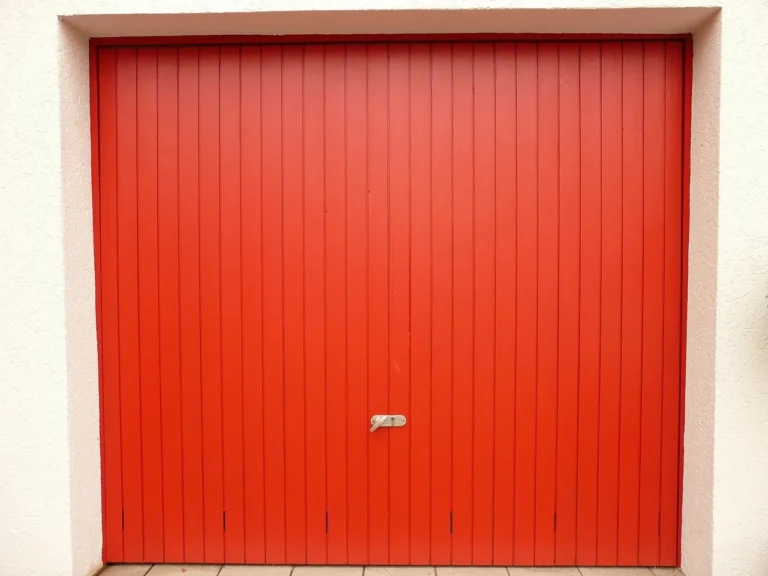 Homeowner beside an open garage door with insulation panels attached inside