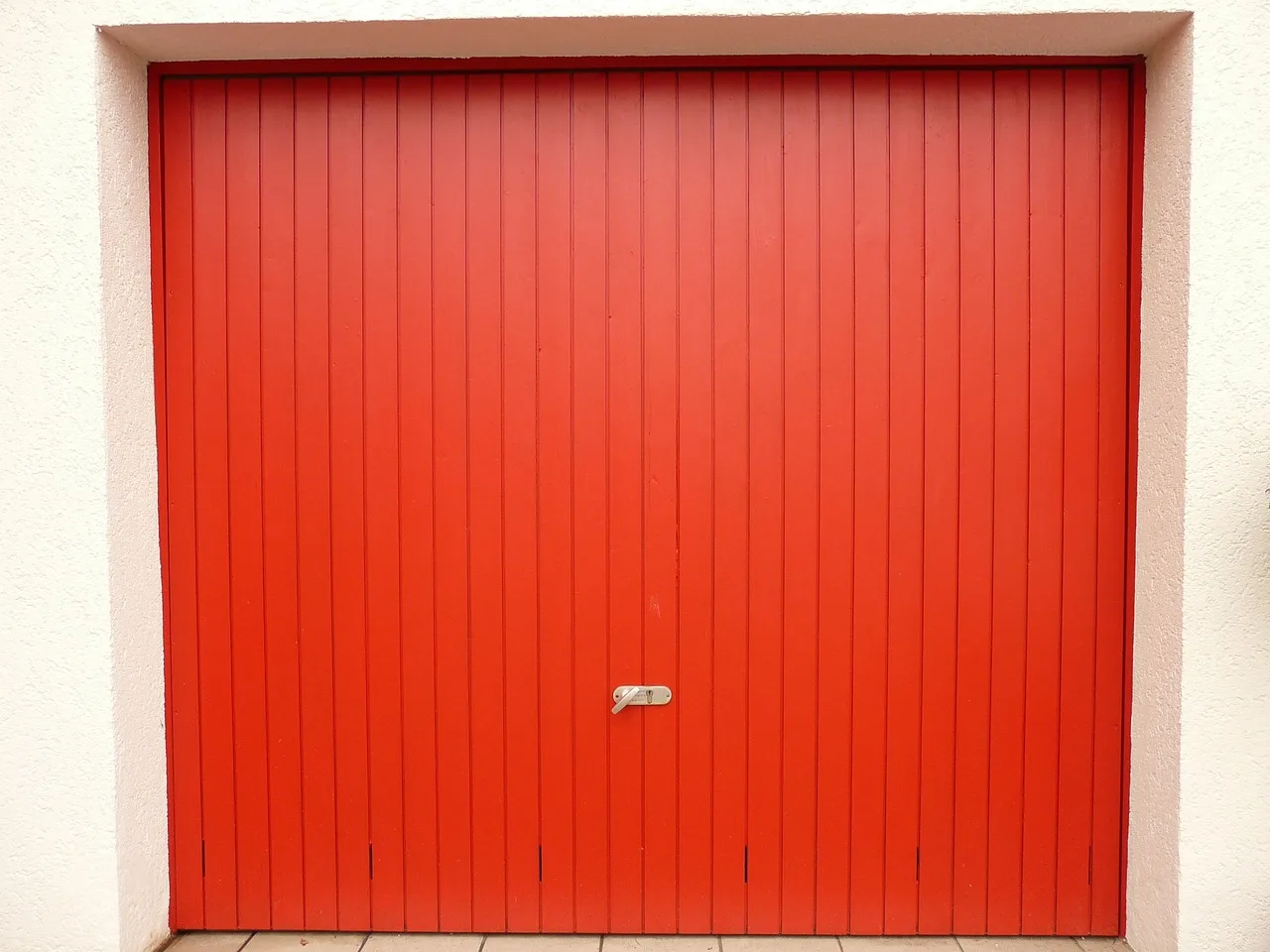 Homeowner beside an open garage door with insulation panels attached inside
