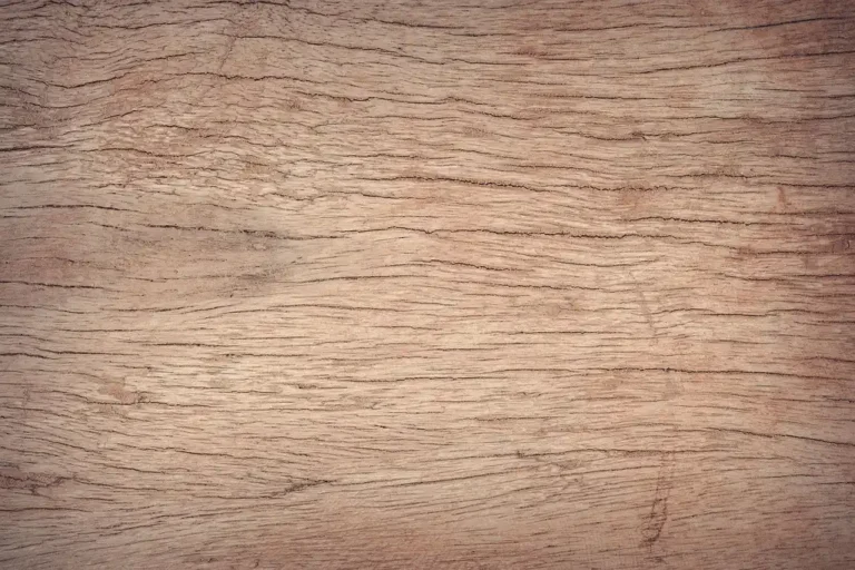 Woodworking bench with pine and oak boards beside hand tools in natural light