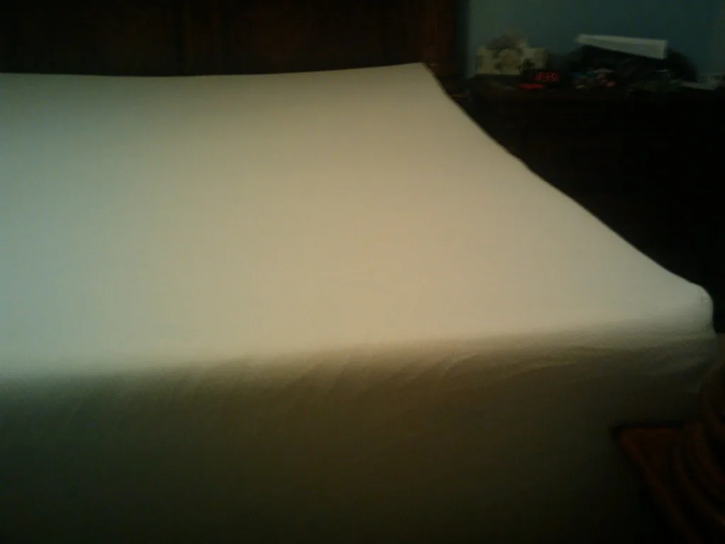 Hand pressing into memory foam mattress to show slow pressure relief