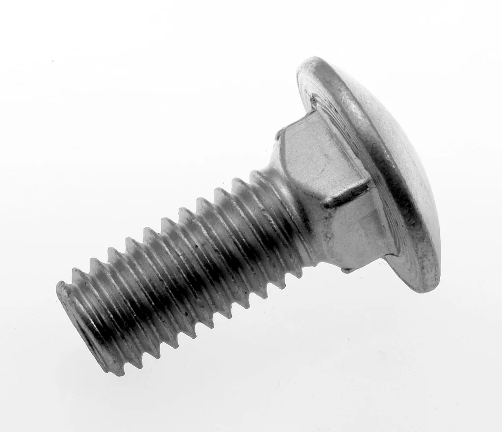 Close-up of a carriage bolt head fitted into a square hole in wood with washer and nut.