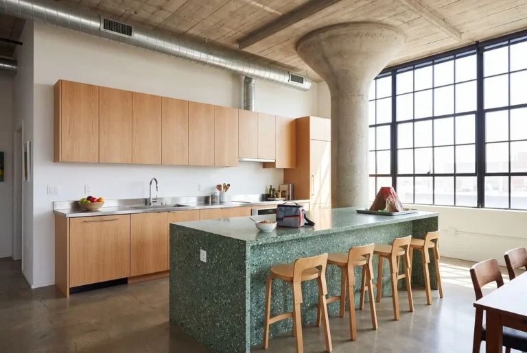 Homeowner and inspector checking kitchen cabinets in a bright showroom