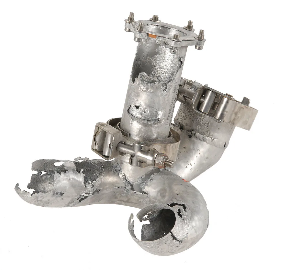 Close-up of a hand turning a plumbing shutoff valve on a water supply line