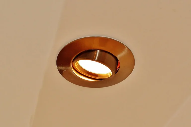 Modern living room ceiling with recessed lights and a track lighting rail side by side