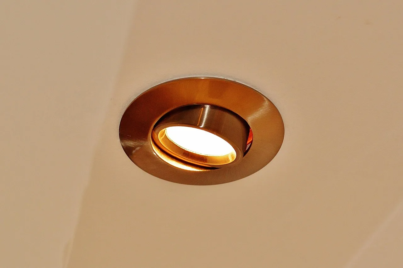 Modern living room ceiling with recessed lights and a track lighting rail side by side