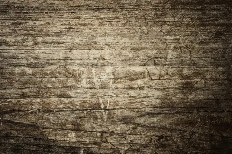 Scratched wooden floorboards with a worn, weathered surface
