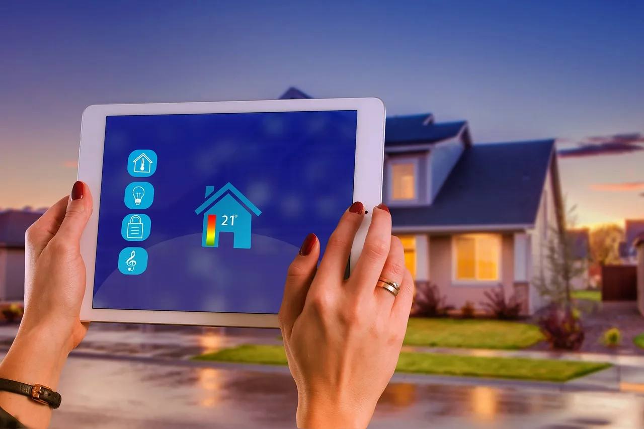 Home Assistant smart home devices arranged on a coffee table beside a laptop in a bright living room