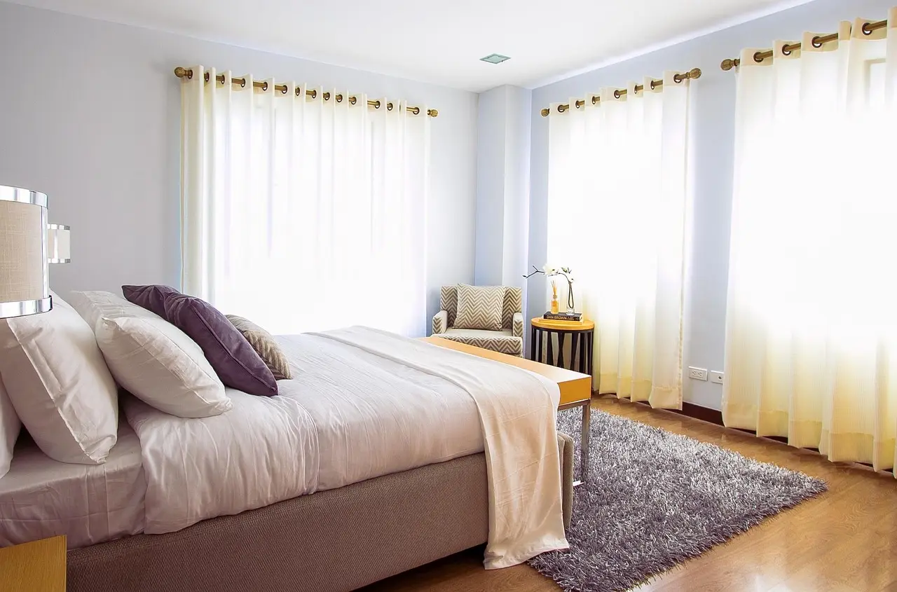 Thermal curtains covering a sealed living room window in a warm, realistic home interior.