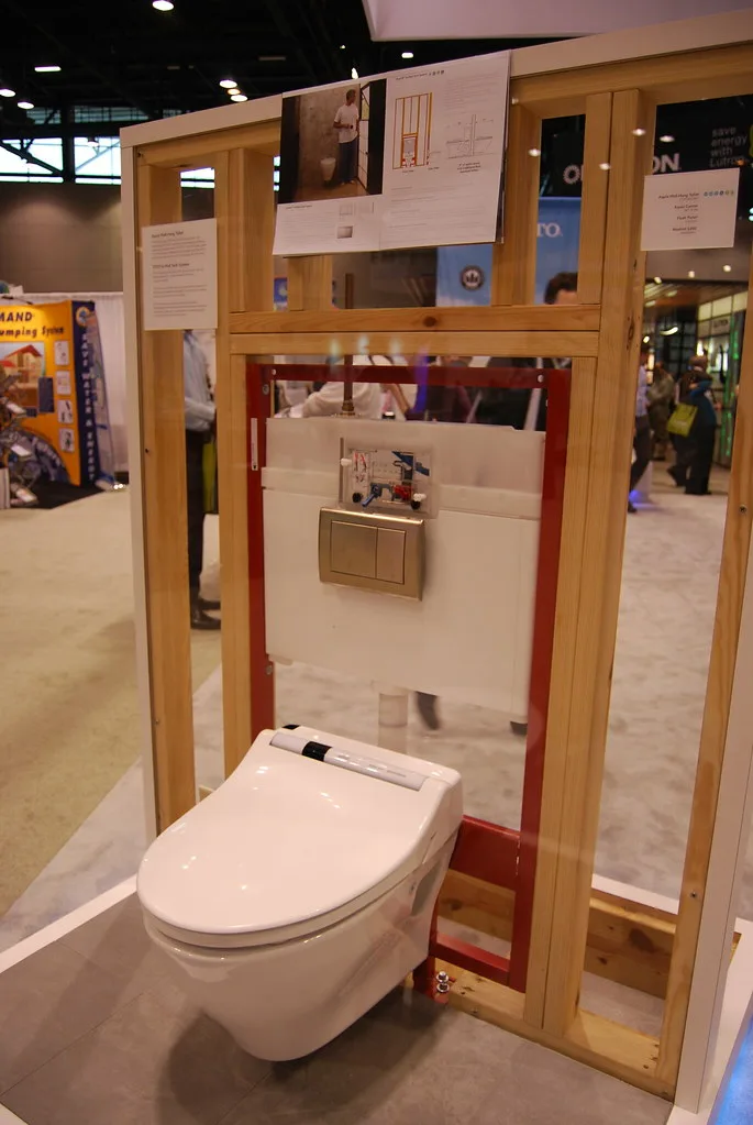 Close-up of a toilet tank showing the fill valve, flapper, chain, and water line