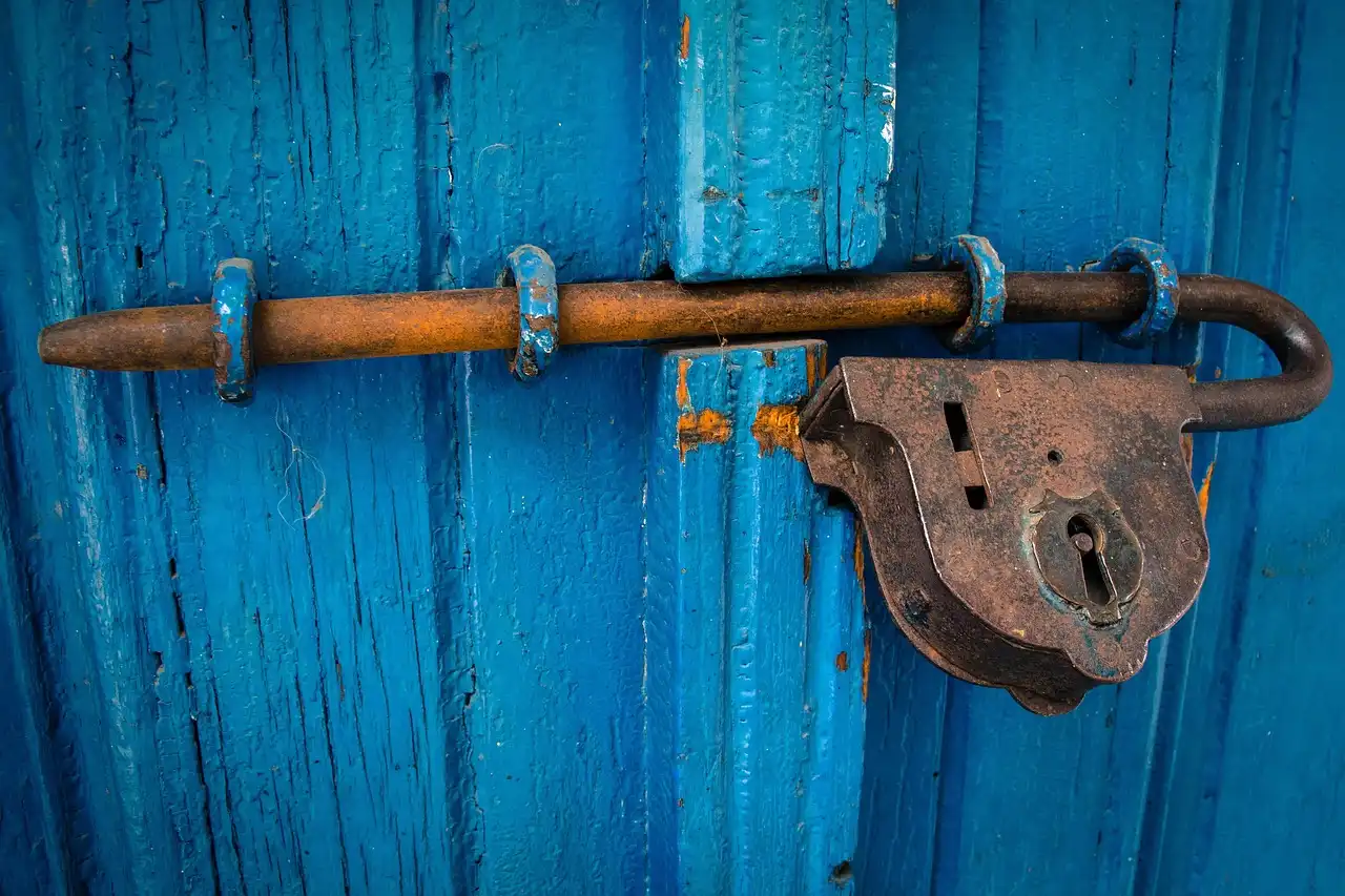 Homeowner inspecting a Haven Door Lock-style device on a front door in natural light
