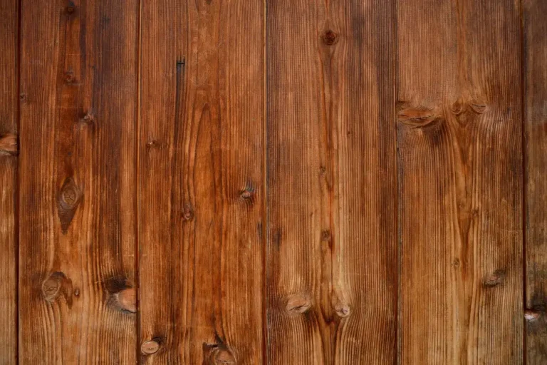 Suburban house exterior with wood siding on one section and composite siding on another